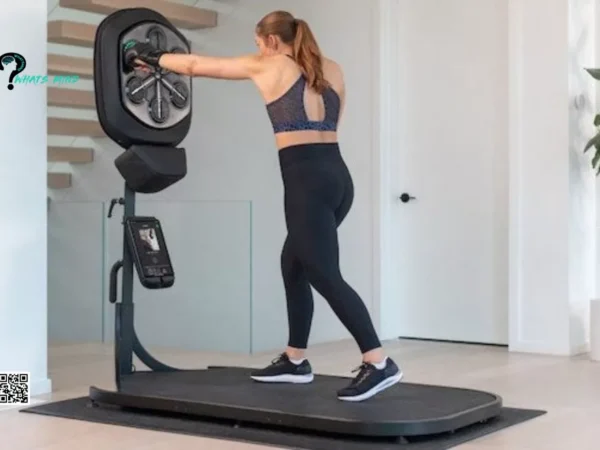 A woman is standing on a treadmill in a liteboxer fitness bundle in a living room.