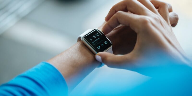 A woman's wrist with an apple watch on it.