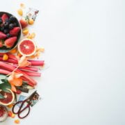 A bowl of fruits and vegetables on a white background.