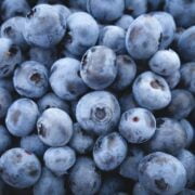 A pile of blueberries on a black background.