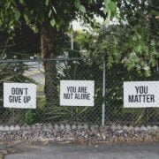 Three signs on a fence that say don't you matter.