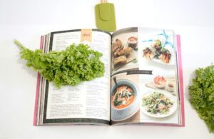 A cookbook with kale and greens on it.