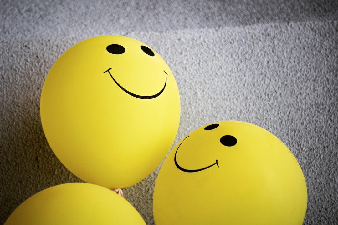 A group of yellow balloons with smiley faces.