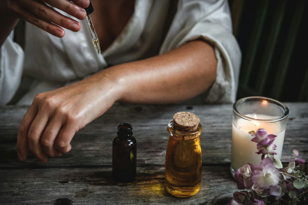 A person applying a dropper on a hand.