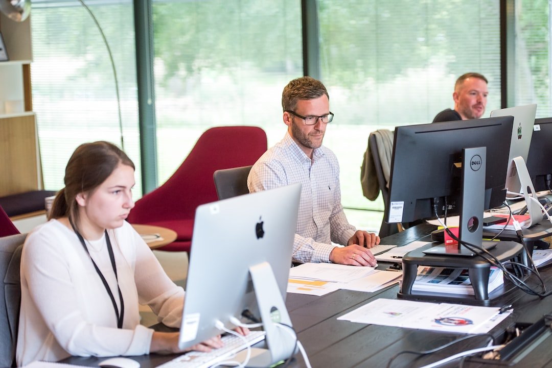 A group of people working on computers in an office.