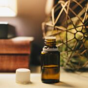 Two bottles of essential oils on a table.