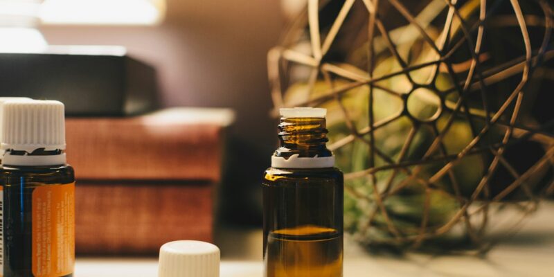 Two bottles of essential oils on a table.