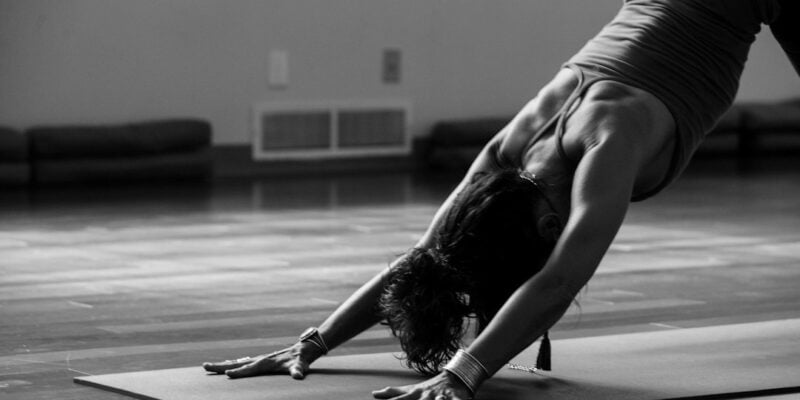 A woman doing yoga on a mat.