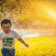 A boy running through water.