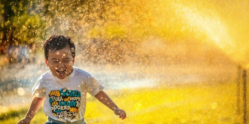 A boy running through water.