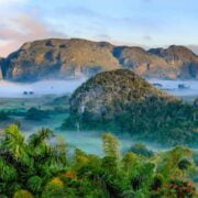 A landscape with mountains and fog.