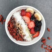 A bowl of granola with berries and nuts.