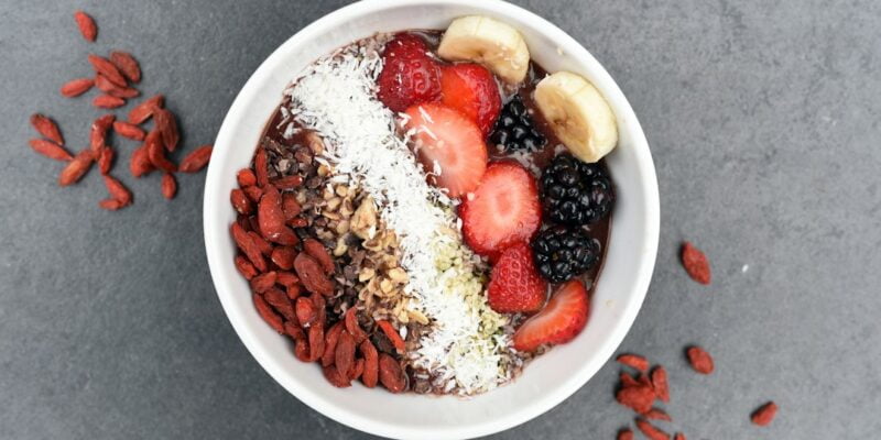 A bowl of granola with berries and nuts.