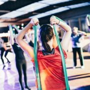 A group of people doing yoga in a gym.