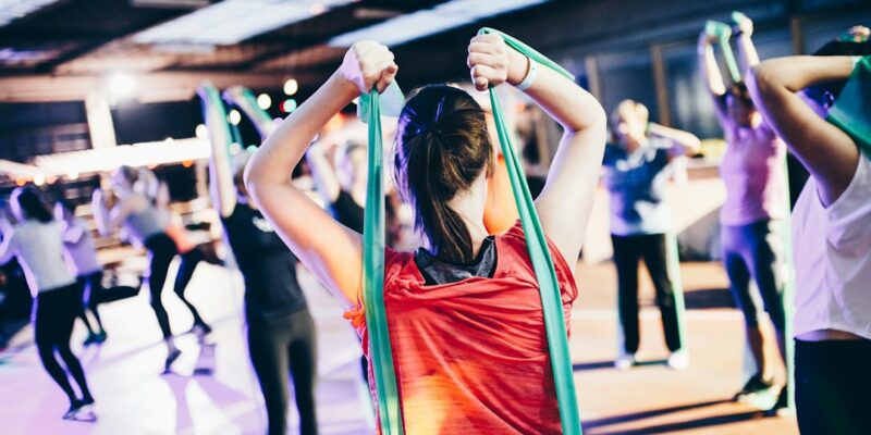 A group of people doing yoga in a gym.