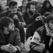 A group of people sitting on the ground.