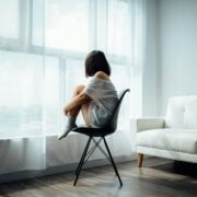 A woman sitting on a chair.