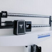 A medical scale hanging on a wall.