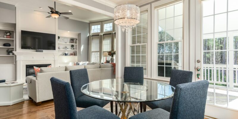 A dining room with a glass table and chairs.