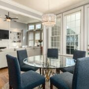 A room with a glass table and chairs.