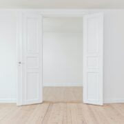 A white room with open doors.