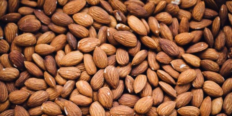 A close up image of a pile of almonds.