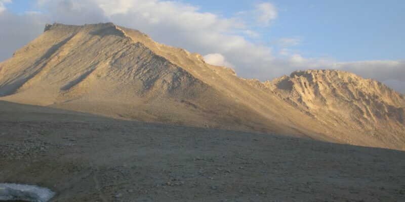 A mountain range with a lake in the background.