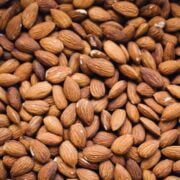 A close up image of a pile of almonds.