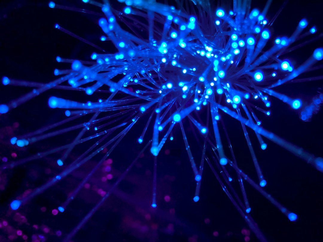 A close up of blue fibers in the dark.