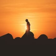 A person standing on a rock.