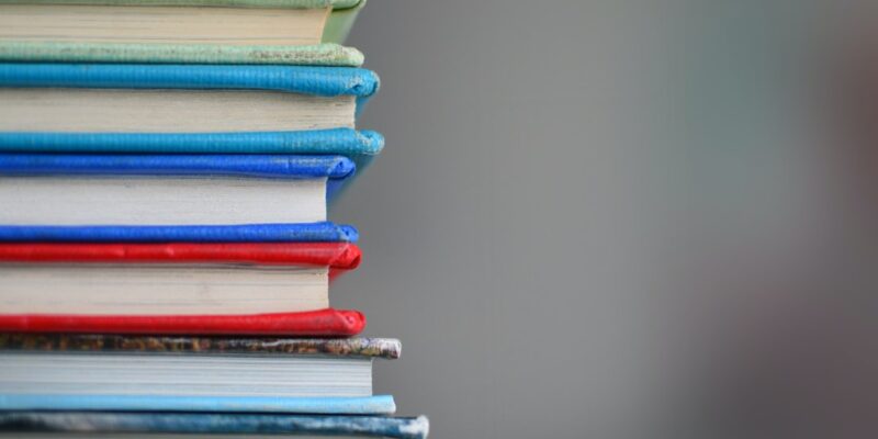 A stack of books with different colored covers.