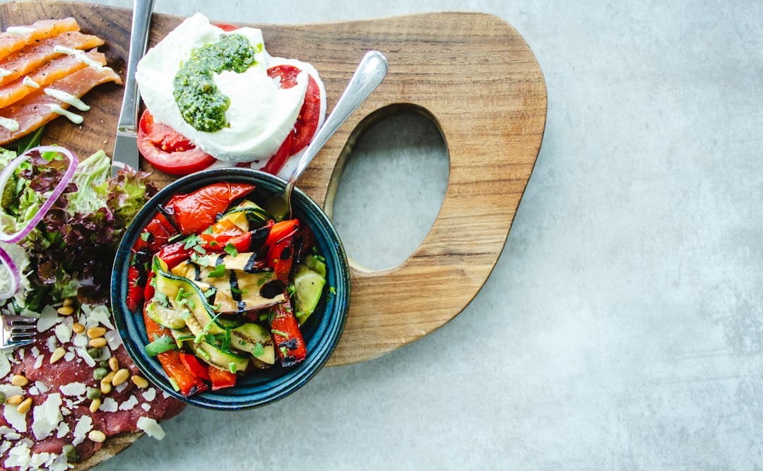 A wooden cutting board with a variety of food on it.