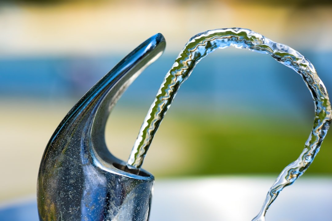 A water flowing out of a faucet.