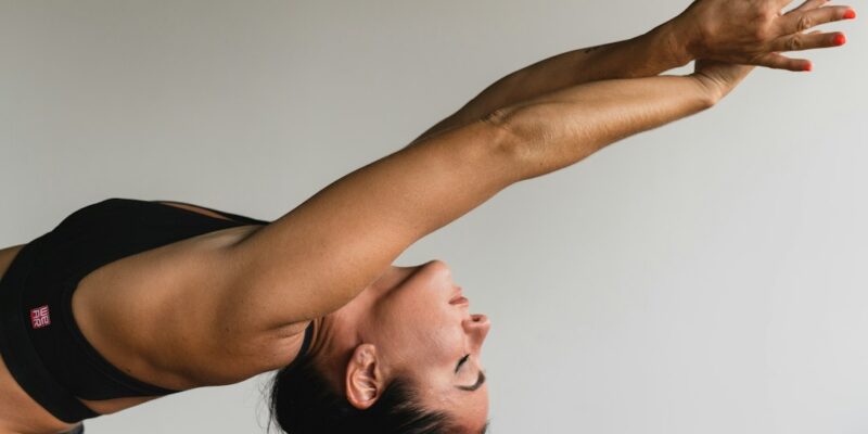 A woman doing a yoga pose in a room.