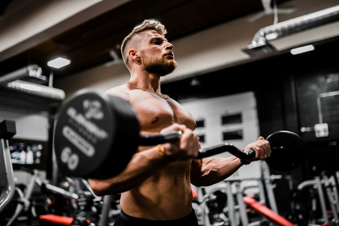 A man lifting weights in a gym.