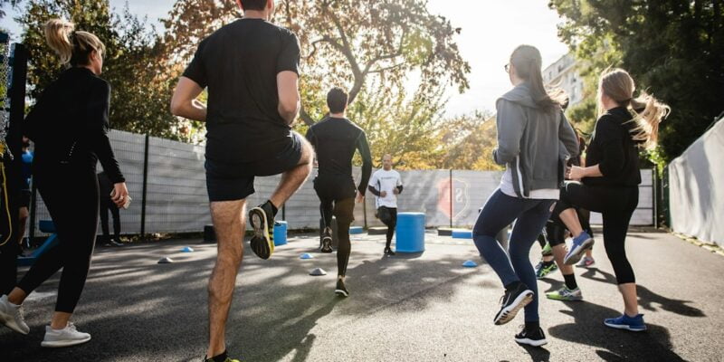 A group of people running in a park.