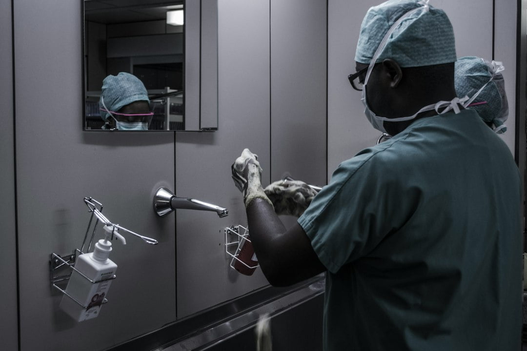 A person washing hands in a bathroom.