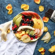 A plate of fruit and chocolate.