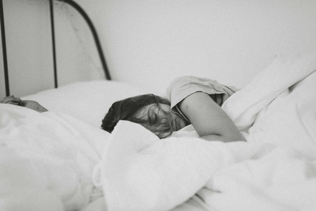 A woman sleeping in a bed.