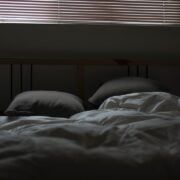 Pillows on a bed with a window.