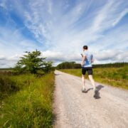 A man running on a dirt road.