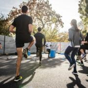 A group of people running on a street.