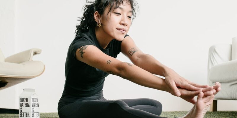 A woman doing yoga in a living room.