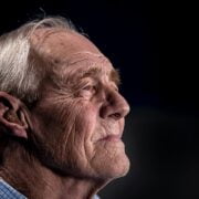 An older man looking up at the sky.