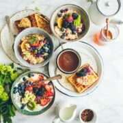 A table with plates of food and a cup of coffee.