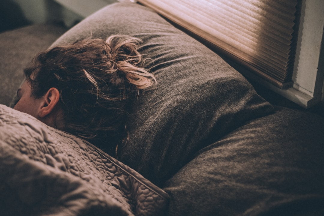 A person sleeping on a couch.