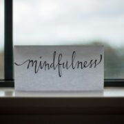 A card with the word mindfulness sitting on a window sill.