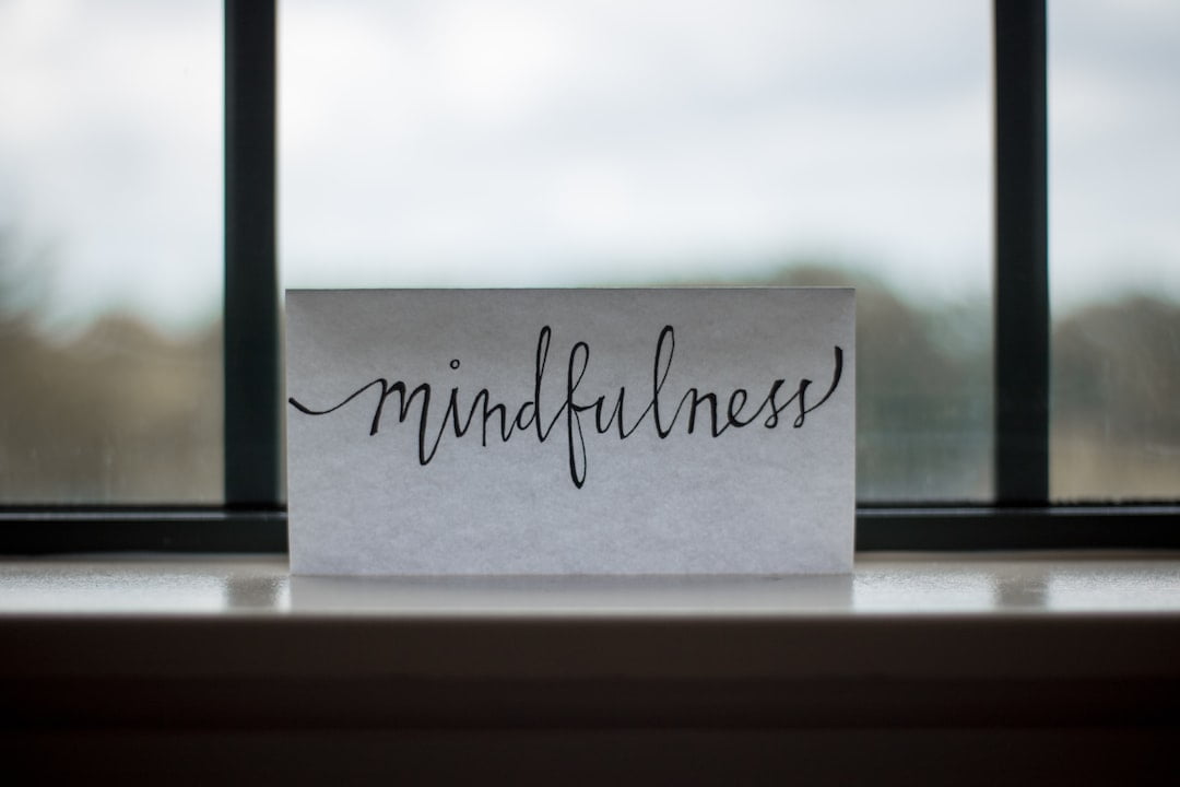 A card with the word mindfulness sitting on a window sill.