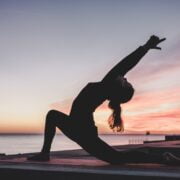 A woman doing yoga on a rooftop.