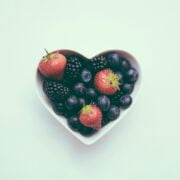 A bowl of berries in a heart shape.